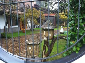 a cage with a fire hydrant in a yard at Bed & Breakfast Villa Chiara in Magenta