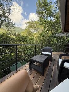 a woman laying on the deck of a house at SeTena Tierra Humeda Ecolodge in Minca