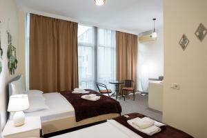 a hotel room with a bed and a table with chairs at Chill Out Hotel Tskaltubo in Tsqaltubo +74 photos