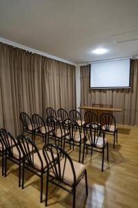 a room with a bunch of chairs in front of a screen at Chill Out Hotel Tskaltubo in Tsqaltubo