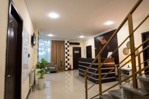a hallway with a staircase and a living room at Chill Out Hotel Tskaltubo in Tsqaltubo