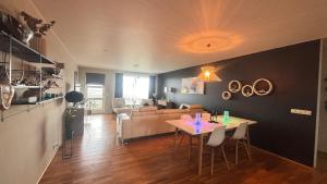 a living room with a table and a couch at Akranes Sunset Apartment in Akranes