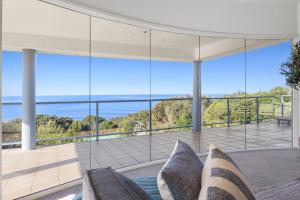 a living room with a couch and a view of the ocean at Ultimate Ocean Views - Pet Friendly in Bellbrae