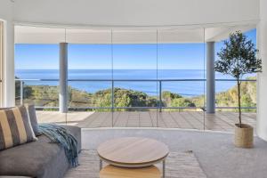 a living room with a couch and a table at Ultimate Ocean Views - Pet Friendly in Bellbrae +45 photos