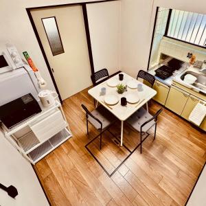 a small kitchen with a table and chairs in a room at Between Kyoto & Osaka 渚西 駅徒歩6分 in Hirakata