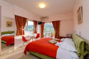 a bedroom with two beds and a table and chairs at Ktima Anastasia Olive Grove Nafplio in Nafplio