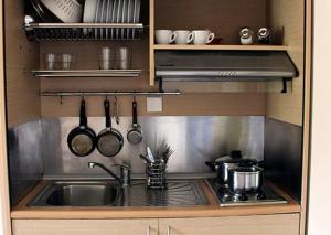 a kitchen with a sink and a stove with utensils at Ktima Anastasia Olive Grove Nafplio in Nafplio