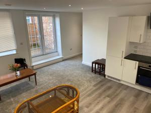 an empty living room with a kitchen and a table at Have a fun and rest in Hull +44 photos