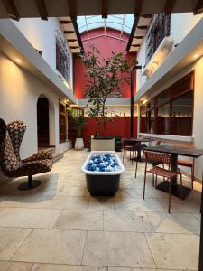 a lobby with a large tub and chairs and a table at Sereno Hostels in Bogotá