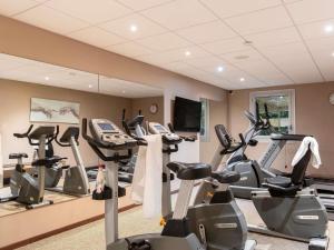 a gym with a bunch of exercise bikes and a mirror at ibis Rouen Centre Champ de Mars in Rouen