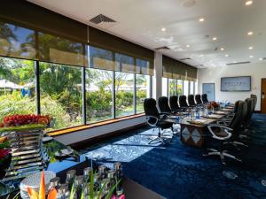 a conference room with long tables and chairs and windows at Sofitel Fiji Resort & Spa in Denarau +287 photos