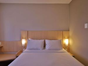 a bedroom with a large bed with two white pillows at ibis Recife Boa Viagem in Recife +111 photos