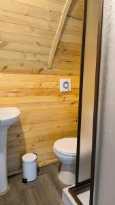 a wooden bathroom with a toilet and a sink at Elimar Ocean View in Valdivia +20 photos