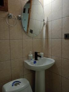 a bathroom with a toilet and a sink and a mirror at Pyramidal Park Valdivia in Valdivia +48 photos