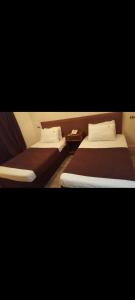 two beds in a room with two beds sidx sidx sidx at New Sandy Hotel in Marsa Matruh +2 photos
