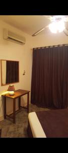 a bedroom with a desk and a bed and a table at New Sandy Hotel in Marsa Matruh