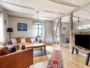 a living room with a couch and a tv at Alma in Zierow