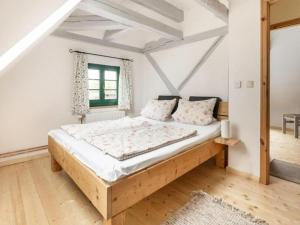 a bedroom with a wooden bed in a room at Alma in Zierow