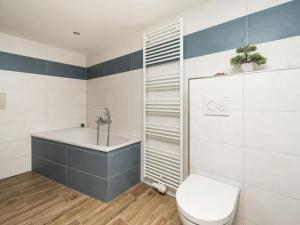 a bathroom with a tub and a toilet and a sink at Alma in Zierow +21 photos