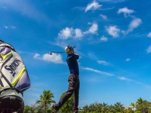 a man swinging a golf club in the sky at Sofitel Krabi Phokeethra Golf and Spa Resort in Klong Muang Beach