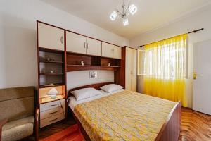 a bedroom with a bed in a room with a window at Apartments by the sea Grscica, Korcula - 169 in Prizba