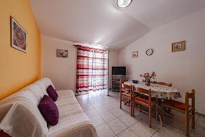 a living room with a couch and a table at Apartments by the sea Grscica, Korcula - 169 in Prizba