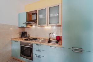 a kitchen with a sink and a refrigerator at Apartments by the sea Grscica, Korcula - 169 in Prizba