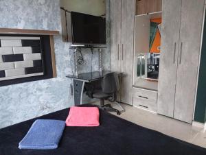 a bedroom with a bed and a desk and a television at hospedaje dorado engativá in Bogotá