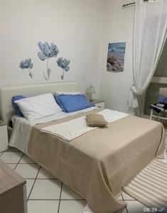 a bedroom with a large bed with blue and white pillows at Appartamento ANGIE in Forio d'Ischia