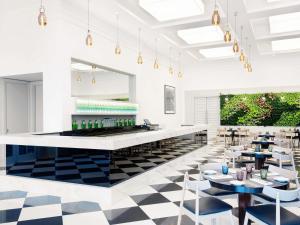 a restaurant with a black and white checkered floor at ibis Deira Creekside Dubai in Dubai