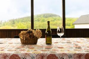a bottle of wine sitting on a table with a glass at Chaloupka nedaleko Monínce in Sušetice