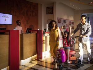 a family standing in a store with a child on a cart at ibis Jaipur City Centre - An Accor Brand in Jaipur +74 photos