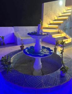 a table with a candle on it in a room with stairs at Maison vue mer in Rafrāf