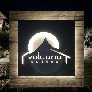 a sign for a vocalot suites at night at Volcano Suites in Puyehue