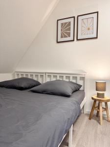 a bedroom with a bed with two pillows and a table at Modernes Apartment am Bodensee in Singen