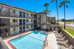 a swimming pool in front of a building with chairs at Studio 6-Fairfield, CA - Napa Valley in Fairfield