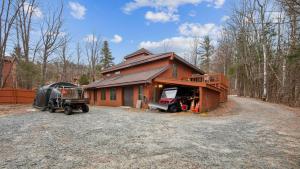 a house with a truck parked in front of it at Sleeping Bear by AvantStay in North Creek