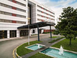 a hotel with a fountain in front of a building at Novotel Trabzon in Trabzon
