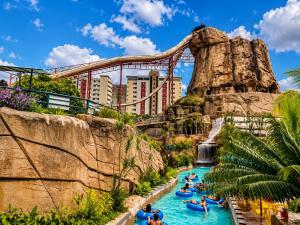 a group of people in a lazy river in the water park at diRoma Luxo Oficial Apt mais diRoma Acqua Park e Splash e Slide , 3 parques Aquáticos , Roupa de Cama e Toalhas, Parcelamos até 12x no Cartão de Crédito sem Juros , Aceitamos Pet in Caldas Novas