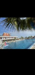 a view of a body of water with a resort at Hotel JF Dhërmi in Dhërmi