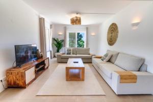 a living room with a couch and a tv at Villa Ursa by Algarve Holidays in Praia do Carvoeiro