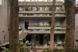 an apartment building with plants on the balconies at Casa Levora in Mexico City