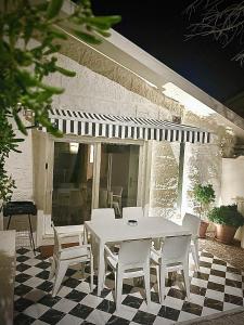 a white table and chairs on a patio at 30m to Beach - Mindelo Ocean House in Mindelo