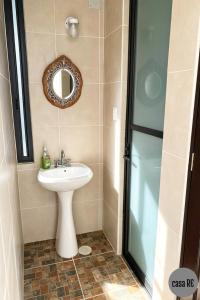 a bathroom with a sink and a mirror at Habitación 4 Jiotilla Casa Re in Tehuacán +15 photos