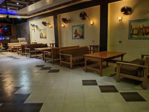 a dining room with wooden tables and chairs at blue Bird in Nuweiba‘ el Muzeinah