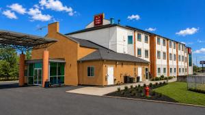 a building with a red sign on top of it at Econo Lodge Menomonie in Menomonie