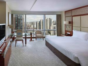 a hotel room with a large bed and a large window at Pullman Shanghai Central in Shanghai