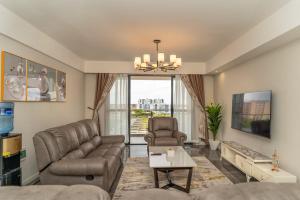 a living room with a couch and a chair at Spectacular 3 bedroom apartment in Syokimau