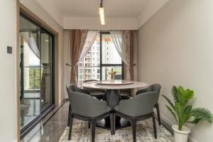 a dining room with a table and chairs and a window at Spectacular 3 bedroom apartment in Syokimau