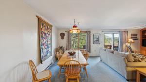 a living room with a table and a couch at Quick Silver - Summit at Gore Mountain by AvantStay in North Creek